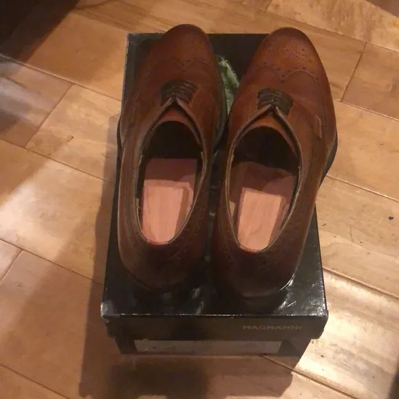 New and never worn Brown Magnanni size 12 wingtip men’s shoes.