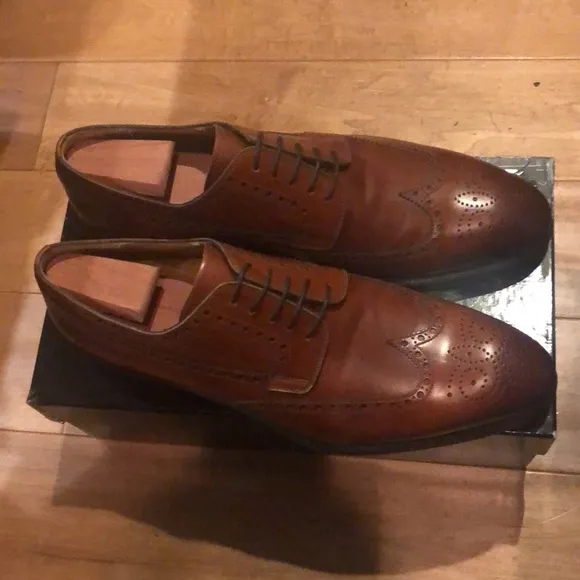 New and never worn Brown Magnanni size 12 wingtip men’s shoes.